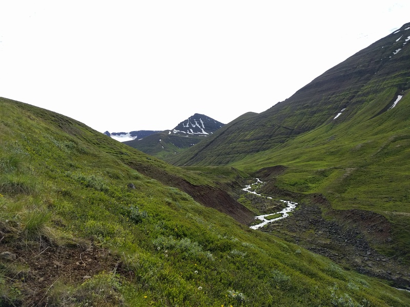 another river cutting
through a valley showing the erosive process in action