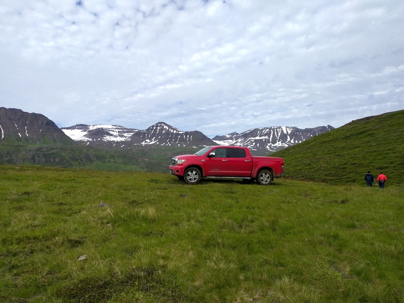 pickup truck in front of
large mountains