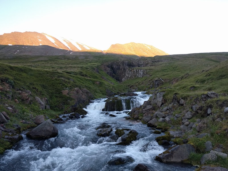 yet another river
descending in a valley out of a grass-covered hill
