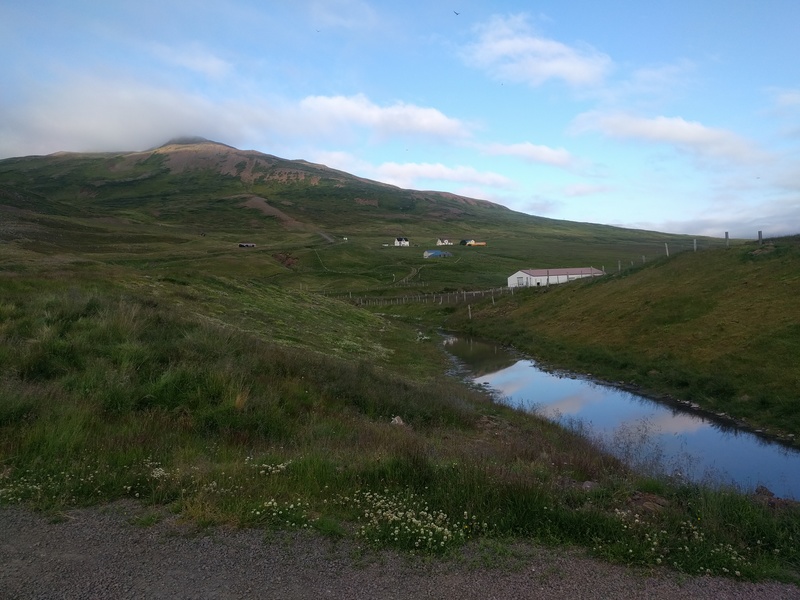 a few small buildings on a
hilly landscape