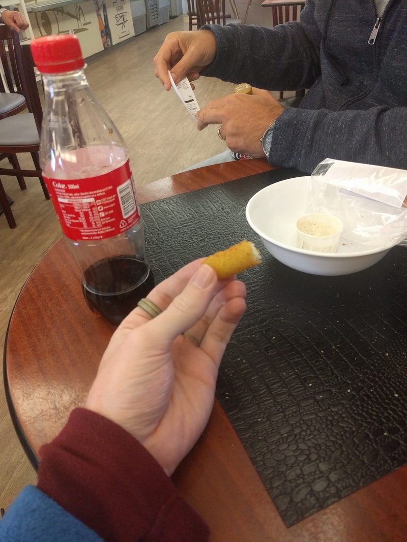 a half eaten mozzarella
stick and a coke